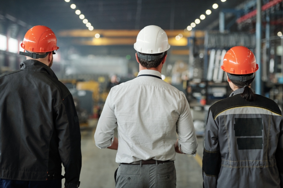 manufacturing consultants with hard hats in a factory